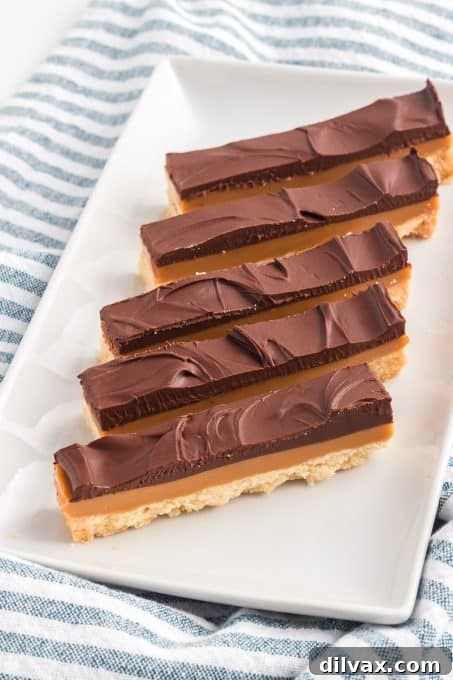Golden Layered Indulgence 9 Homemade Twix aka Millionaire Bars on a cooling rack.