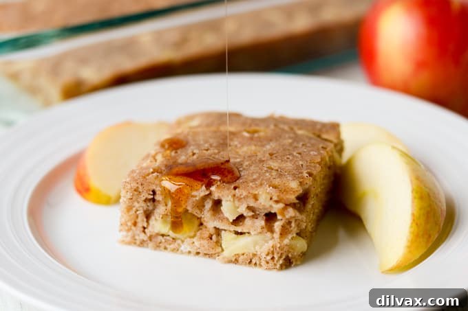 A delicious slice of Baked Apple Cinnamon Pancake, showcasing the golden-brown crust and juicy apple pieces.