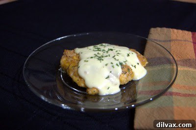 Crispy Cheddar Chicken Day 319 2 Golden-brown Crispy Cheddar Chicken pieces in a baking dish, ready to be served.