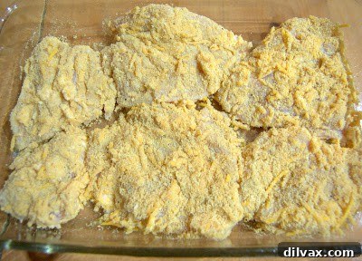 Crispy Cheddar Chicken Day 319 5 Coated chicken pieces arranged in a baking dish, ready for baking.