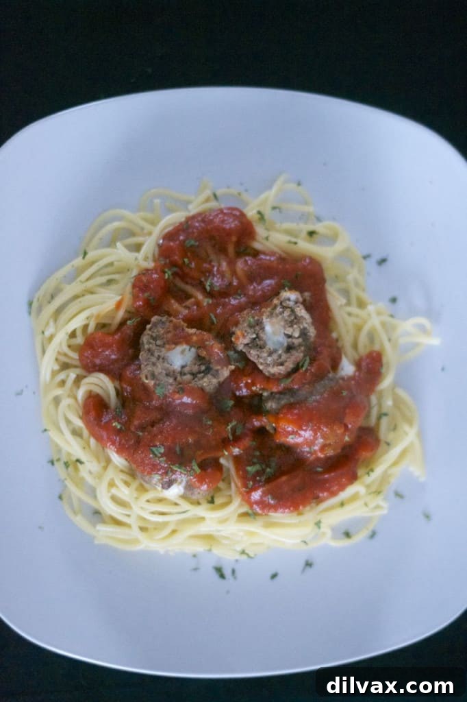 Close-up of a Mozzarella Stuffed Meatball, showcasing its delicious texture