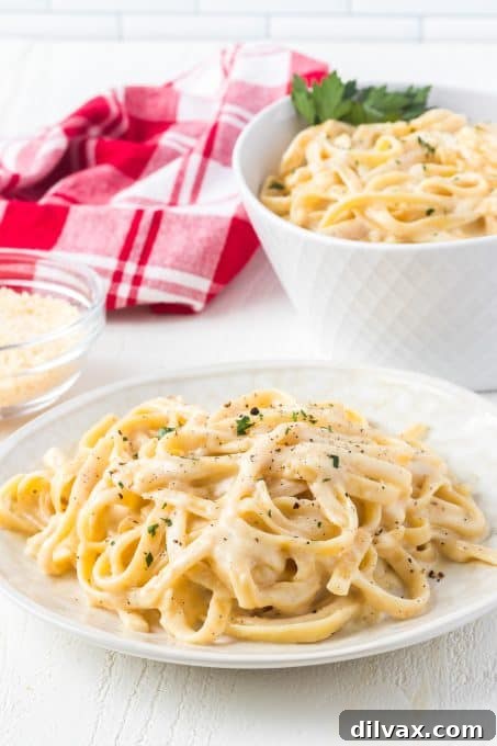 Velvety Garlic Alfredo Fettuccine 10 A generous serving of Garlic Fettuccine Alfredo on a plate, ready to be enjoyed
