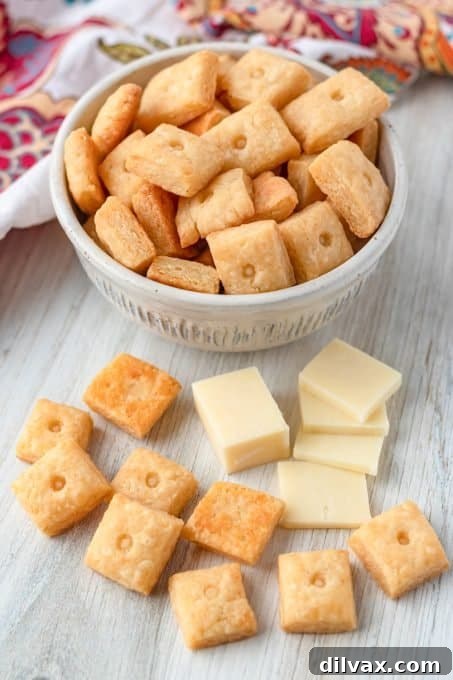 Handcrafted Cheesy Crisps 3 A close-up of a stack of homemade cheese crackers, highlighting their golden color and texture.