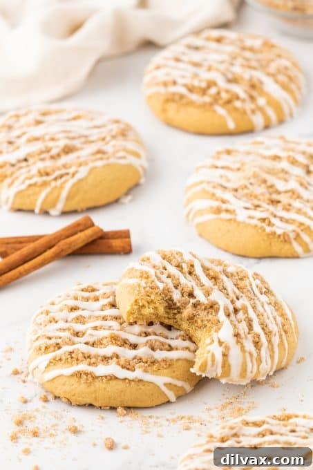 Cinnamon Streusel Cookies 8 A freshly baked Coffee Cake Cookie with glaze, cut in half to show the cinnamon filling inside.