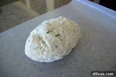 Lightly kneading the dough a few times within the mixing bowl.