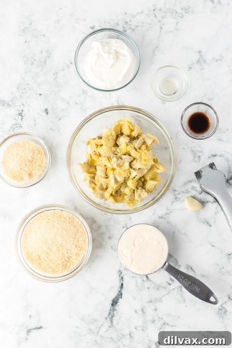 Fresh ingredients laid out for making the ultimate baked artichoke dip.
