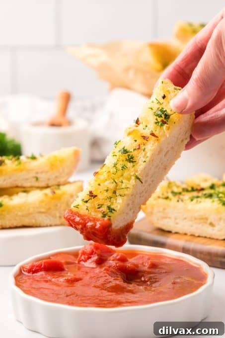 Lightning Fast Air Fryer Garlic Bread 11 Dipping bread in a marinara sauce.