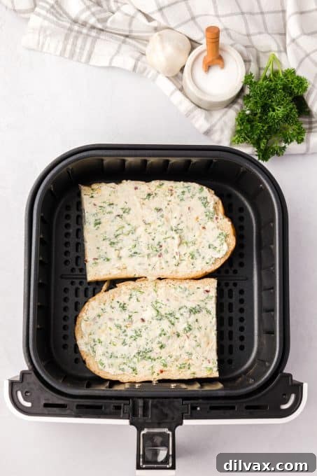 Effortless Air Fryer Garlic Bread Pronto 6 Bread with a spread of garlic butter on it.