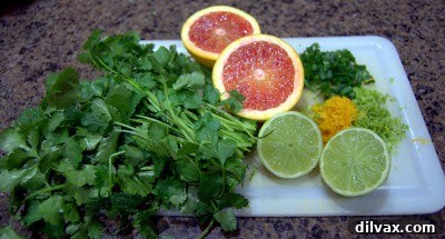 Fresh cilantro, a blood orange, and a lime, key ingredients for the vibrant citrus sauce.