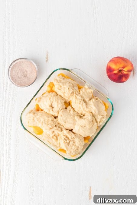 Effortless Golden Peach Cobbler 8 Dollops of cobbler dough carefully placed over the juicy peaches