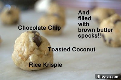 Close-up of a single Brown Butter Coconut Krispie Chocolate Chip Cookie, showing its unique texture.