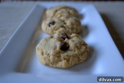 Freshly baked Brown Butter Coconut Krispie Chocolate Chip Cookies on a cooling rack.