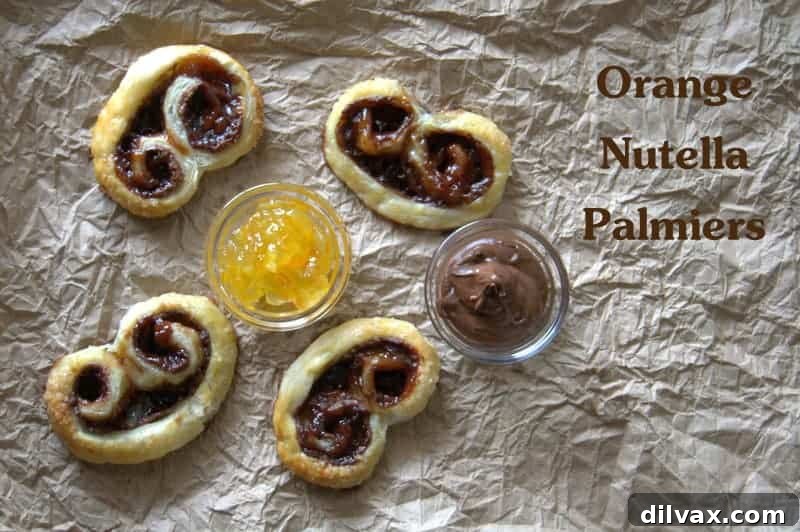 Delicious Orange Nutella Palmiers on a baking sheet, showcasing their flaky crust and sweet filling.