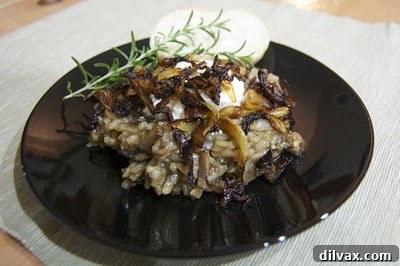Golden Caramelized Onion and Mushroom Risotto Bake 2 A beautifully plated bowl of steaming Baked Mushroom Risotto, garnished with fresh herbs and rich caramelized onions, ready for dinner.