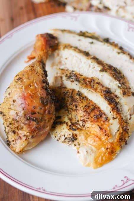 Slices and a drumstick of a Lemon Herb Roasted Chicken.