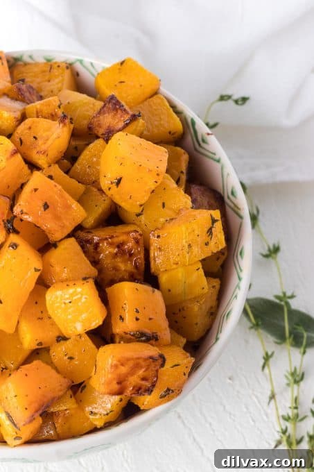 Golden Roasted Butternut Squash 9 A bowl of roasted butternut squash garnished with fresh parsley