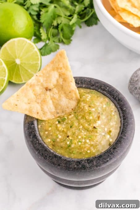 Vibrant Green Salsa 8 Tortilla chip dipping in a tomatillo salsa.