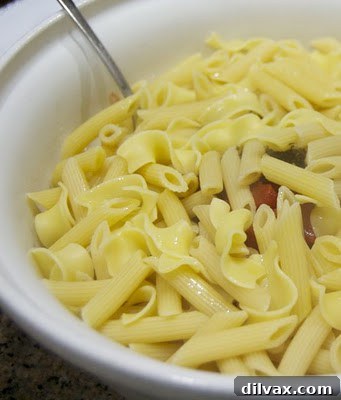Caprese pasta served on a plate, highlighting the simple ingredients.