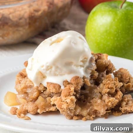 Easy Apple Crisp with a golden crumble topping, served in a white dish.