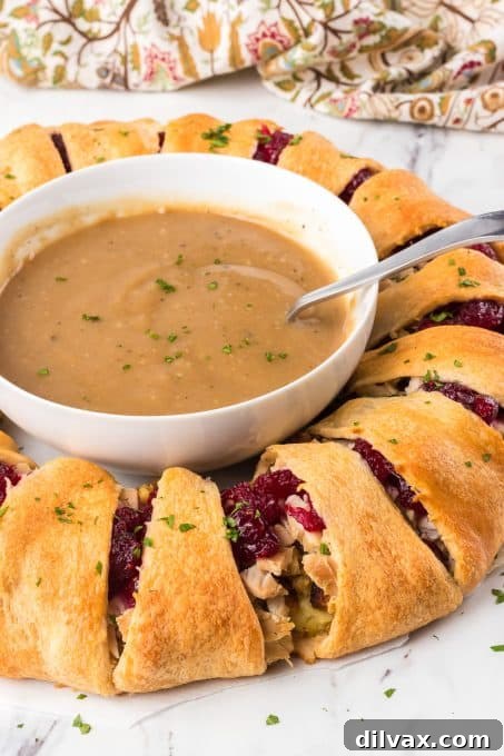 Various Thanksgiving leftovers including cranberry sauce, stuffing, mashed potatoes, and turkey alongside crescent rolls, ready to be assembled into an easy weeknight dinner.