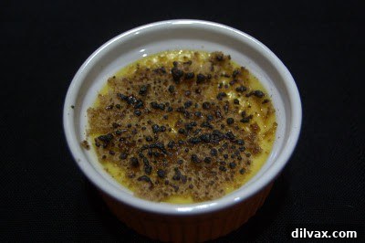 Another angle of crème brûlée with slightly burnt topping