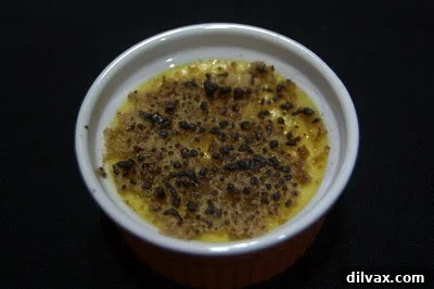 Another example of burnt sugar topping on creme brulee, looking black and uneven.