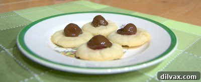 Unwrapping the Flavor: My 12 Days of Cookie Review 2 Chocolate Covered Cherry Thumbprint Cookies with a cherry filling and chocolate drizzle