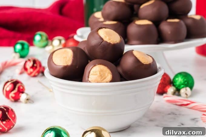 Christmas Buckeye Recipe, a plate full of chocolate-dipped peanut butter balls decorated with festive sprinkles.