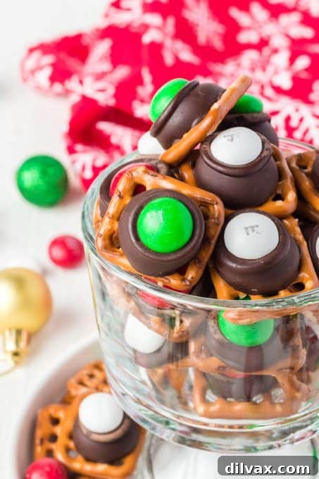 Sweet and Salty Pretzel Magic 5 Close-up of Mint M&M's, Hershey's Mint Kisses, and square pretzels, the core ingredients.