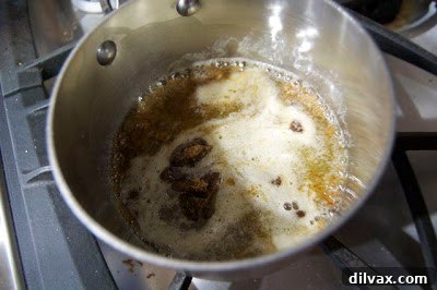 Day 293: A Sticky Letdown 3 Finely chopped pecans being stirred into the butter and sugar mixture for baked toffee