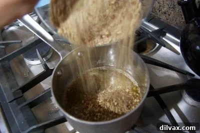 The combined nut and caramel mixture poured evenly into the baking pan, ready to be baked