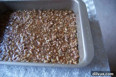 The baked toffee mixture fresh out of the oven, appearing golden brown and slightly puffed