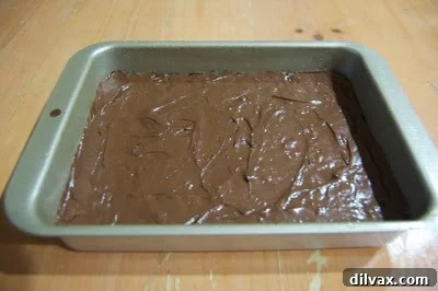 Crumbly baked toffee broken into irregular pieces, revealing its granular, non-uniform texture