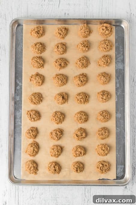 A tray filled with freshly scooped peanut butter cookie dough ready to set.
