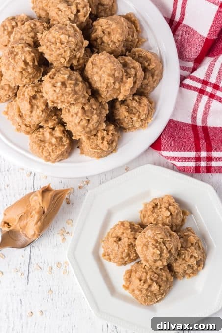 Close-up of three no-bake cookies made with peanut butter, butter, oats, vanilla, and sugar on a white surface.