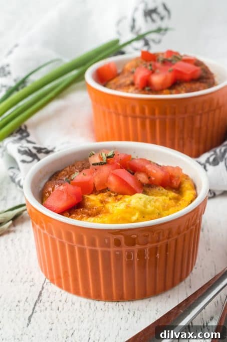 Two baked eggs in ramekins, ready to be served.