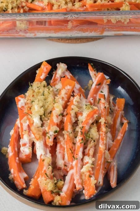 Close-up of freshly made Horseradish Carrots, highlighting the creamy sauce and crispy breadcrumb topping.
