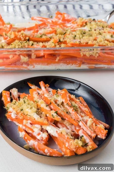 A beautifully presented carrot side dish with a tangy horseradish sauce and a hint of fresh herbs.