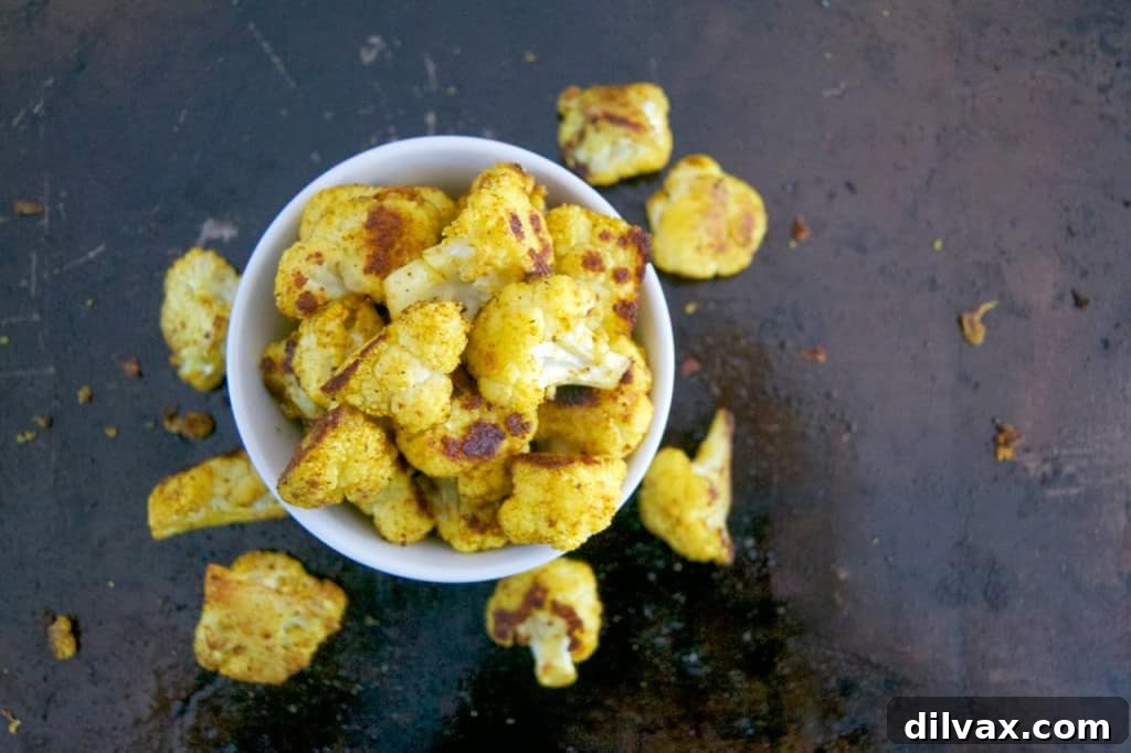 Roasted Curry Cajun Cauliflower - Flavorful cauliflower florets seasoned with aromatic curry and bold Cajun spices, offering a unique blend of South Asian and Louisiana culinary traditions.