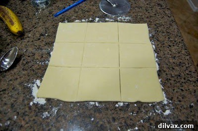 Puff pastry sheet cut into squares.