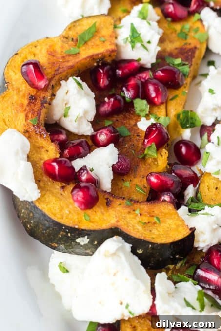 Tangy Roasted Acorn Squash with Goat Cheese 10 Detail of pomegranate arils and goat cheese on baked acorn squash slices.