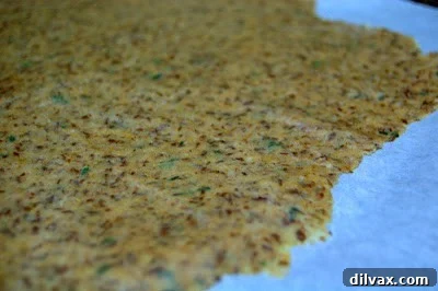 Crunchy Homemade Wheat Crackers 4 Close-up of cracker dough on parchment paper with slight wrinkles.