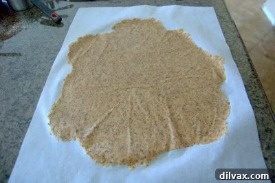 Crunchy Homemade Wheat Crackers 5 Cracker dough being cut into squares with a pizza cutter.