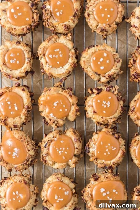 Golden Caramel Thumbprint Bites 7 Delicious Caramel Thumbprint Cookies on a cooling rack, showcasing the golden shortbread base and the smooth, glistening salted caramel filling.