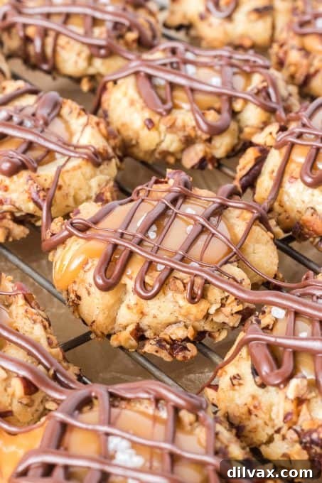 Golden Caramel Thumbprint Bites 8 Close-up of baked shortbread cookies with deep indentations, filled with creamy salted caramel and ready for a chocolate drizzle.