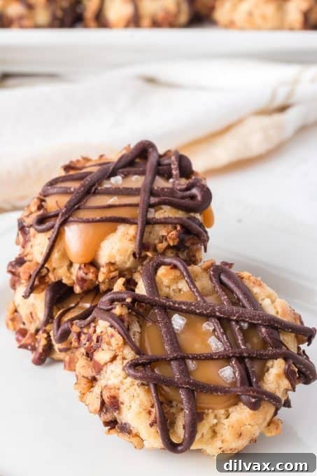 Golden Caramel Thumbprint Bites 9 Finished Salted Caramel Cookies, beautifully drizzled with chocolate, arranged on a cooling rack.