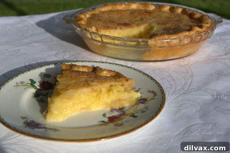 A golden-brown two-crust pineapple pie cooling on a wire rack, a truly delicious treat for pineapple lovers.