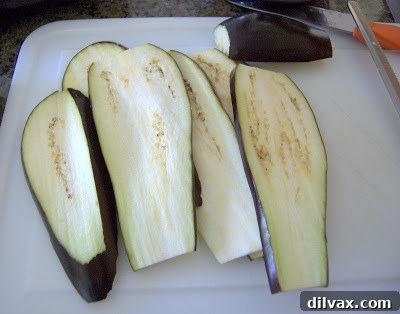 Sliced eggplant strips on a cutting board
