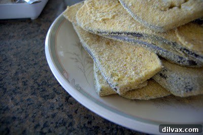 Bredded eggplant slices stacked on a plate