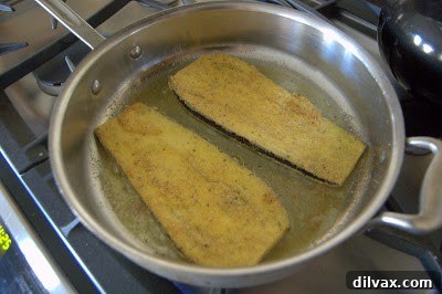 Frying eggplant slices in a skillet